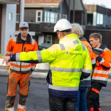 Arbeidere legger asfalt i R&oslash;stbakken.